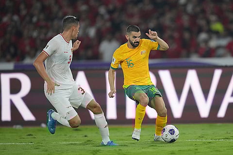 2026 FIFA World Cup Qualifying, Indonesia Australia: Australia's Aziz Behich, right, battles for the ball against Indonesia's Jay Noah Idzes